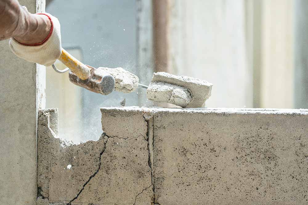 Why Postponing Small Concrete Repairs Leads to Catastrophic Full Demolition Costs